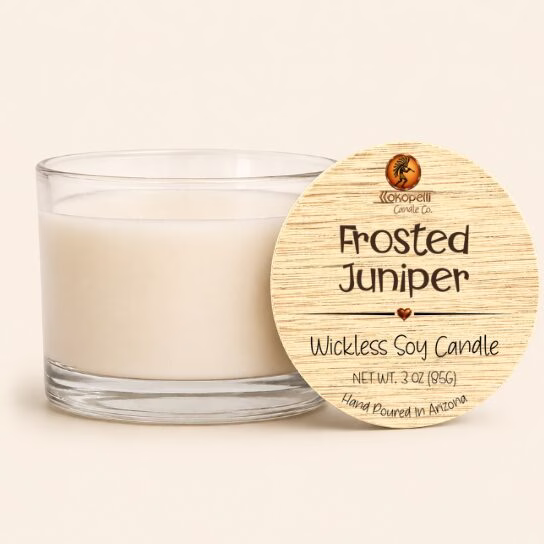 Frosted Juniper wickless soy candle in a clear glass vessel with creamy white soy wax and a natural wood lid, hand poured in Arizona.