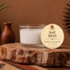 3 oz Fruit Slices wickless soy candle displayed on a natural stone pedestal with warm Southwest décor, handcrafted by Kokopelli Candle Co. in Arizona.