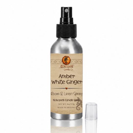 Amber White Ginger Room & Linen Spray by Kokopelli Candle Co displayed with reflective surface and clear cap beside brushed aluminum bottle.