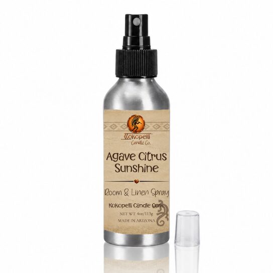 Agave Citrus Sunshine & Linen Spray by Kokopelli Candle Co displayed with reflective surface and clear cap beside brushed aluminum bottle.