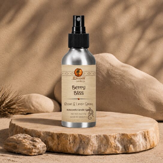 Berry Bliss Room & Linen Spray by Kokopelli Candle Co displayed on a sandstone slab with warm neutral desert-inspired décor and soft natural lighting.