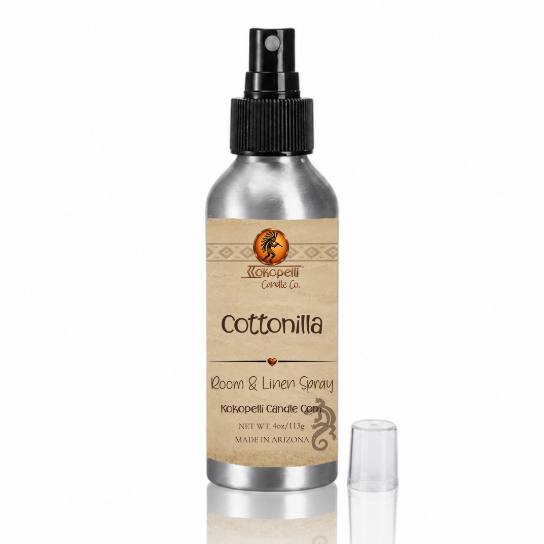 Cottonilla Room & Linen Spray by Kokopelli Candle Co displayed with reflective surface and clear cap beside brushed aluminum bottle.