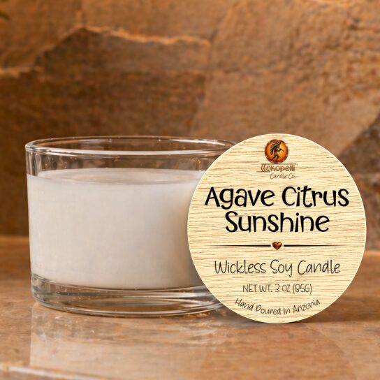 Agave Citrus Sunshine 3oz wickless soy candle by Kokopelli Candle Co displayed on a warm stone surface with clear glass jar and natural wood lid label in a cozy Southwest-inspired setting.
